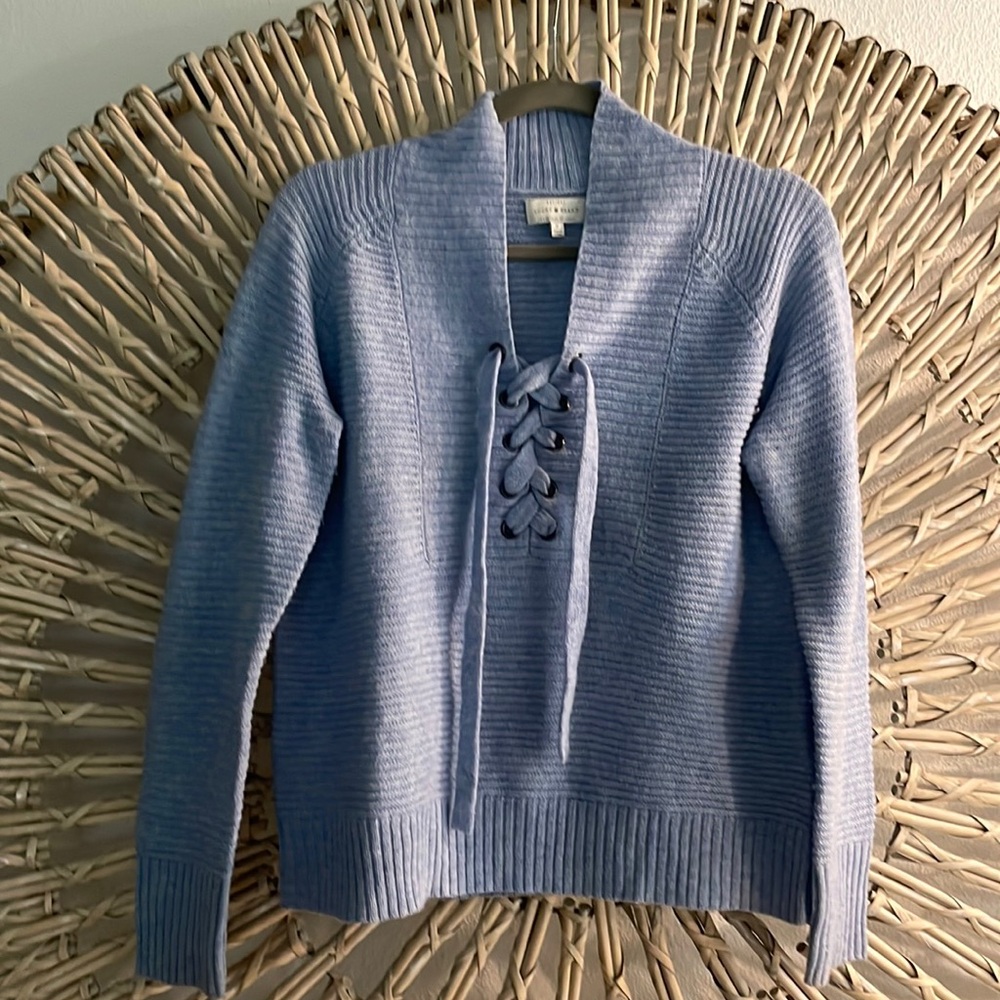 Light blue size Small light weight sweater with lace up detail.